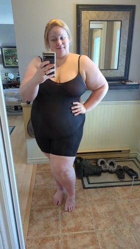 Woman in black dress taking selfie, 30-10-2023.